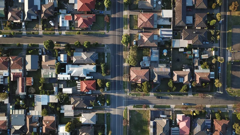 An aerial view of a suburban street of houses